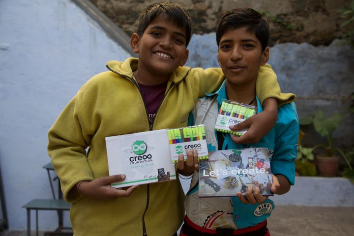 Two boys laughing with their drawings, Udaipur